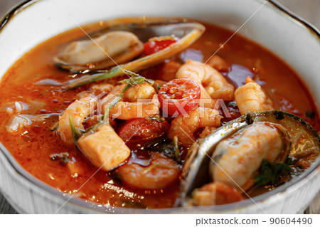 Closeup on bowl of tom yam soup 90604490