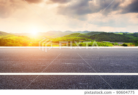 A straightforward bitumen road, the budget village mountains, natural scenery. 90604775