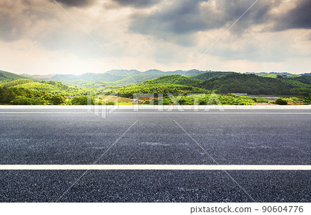 A straightforward bitumen road, the budget village mountains, natural scenery. 90604776