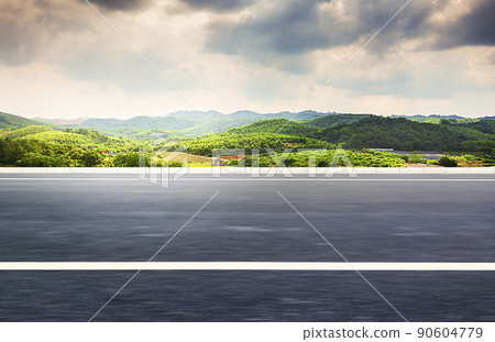 A straightforward bitumen road, the budget village mountains, natural scenery. 90604779