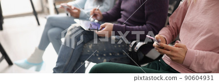People sitting in line and surfing gadgets People sitting in line and surfing gadgets 90604931