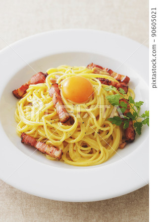 A delicious carbonara with egg yolk on it A delicious carbonara with egg yolk on it 90605021
