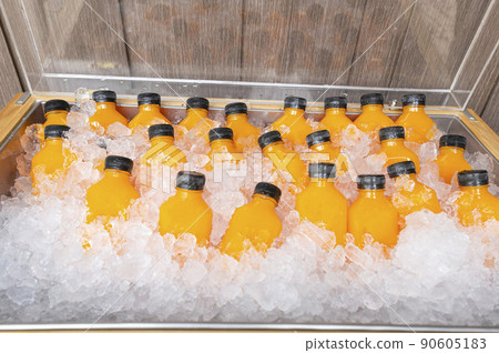 food and drink, orange juice in a bottle with ice food and drink, orange juice in a bottle with ice 90605183
