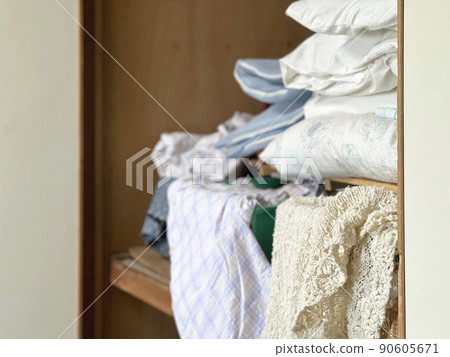 Futons and clothing overflowing from the closet Futons and clothing overflowing from the closet 90605671