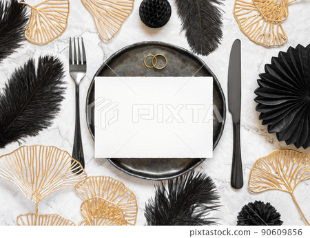 Black and golden wedding table setting with a blank card and rings top view, mockup Black and golden wedding table setting with a blank card and rings top view, mockup 90609856