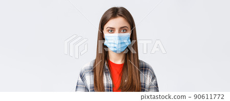 Coronavirus outbreak, leisure on quarantine, social distancing and emotions concept. Close-up of young female student, girl in medical mask looking at camera, normal expression Coronavirus outbreak, leisure on quarantine, social distancing and emotions concept. Close-up of young female student, girl in medical mask looking at camera, normal expression 90611772