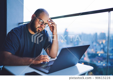 Thoughtful man touching forehead during work 90613228