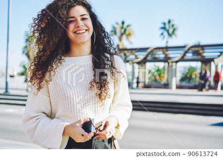 Joyful hipster girl 20s in trendy apparel posing during leisure time on weekend Joyful hipster girl 20s in trendy apparel posing during leisure time on weekend 90613724