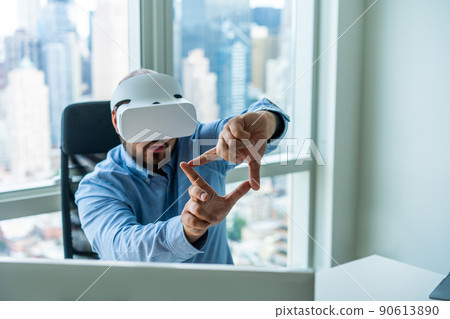 Focused businessman in VR glasses showing frame gesture Focused businessman in VR glasses showing frame gesture 90613890