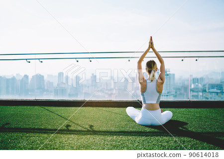 Woman practicing yoga on rooftop in sunny day Woman practicing yoga on rooftop in sunny day 90614018