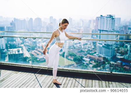 Sporty woman warming up before training 90614035