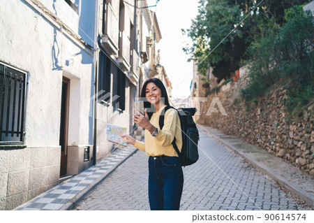 Positive ethnic woman talking on video chat on smartphone 90614574