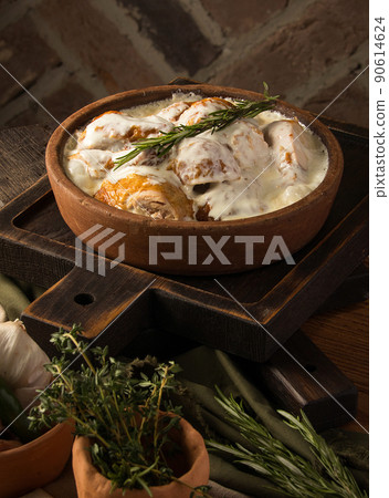 Vertical shot of a chicken covered in a creamy sauce Vertical shot of a chicken covered in a creamy sauce 90614624