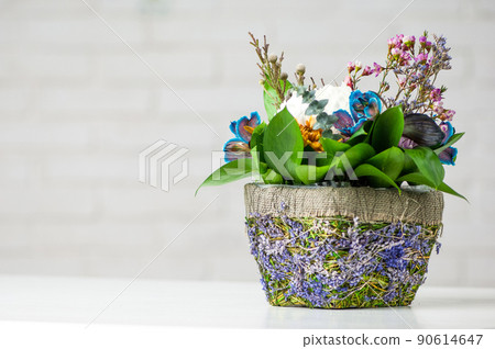 Closeup shot of pot with flowers on white background 90614647
