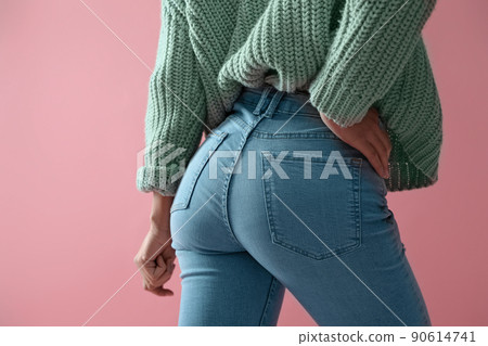 Woman wearing jeans on pink background, closeup Woman wearing jeans on pink background, closeup 90614741