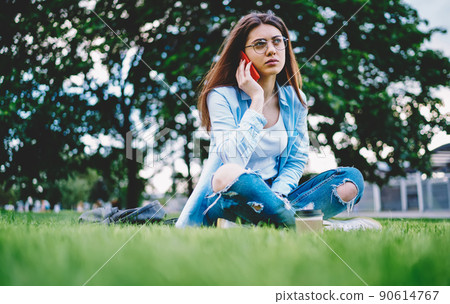 Contemplative female calling to operator for conversation consultancy during leisure time Contemplative female calling to operator for conversation consultancy during leisure time 90614767