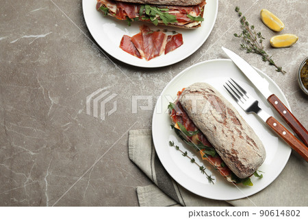 Flat lay composition with delicious sandwich on marble table. Space for text 90614802