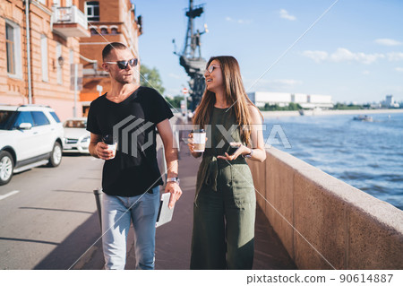Carefree hipster guys in sunglasses talking while walking during date bonding 90614887