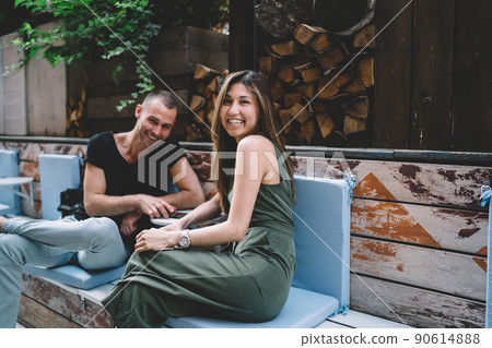 Portrait of cheerful male and female lovers enjoying time for flirting during date time in sidewalk cafe 90614888