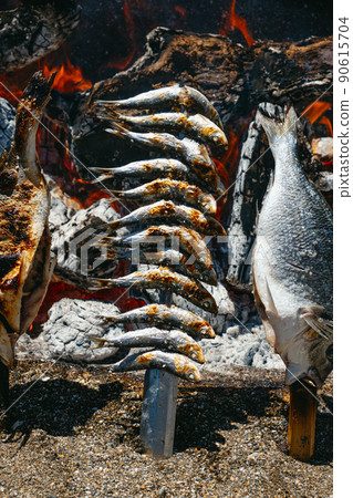 cooking typical espetos of Malaga, Spain cooking typical espetos of Malaga, Spain 90615704