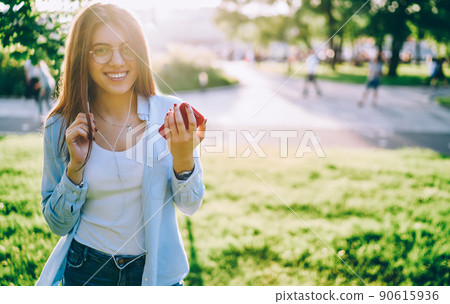 Happy Caucasian user with mobile phone listening positive audio song 90615936
