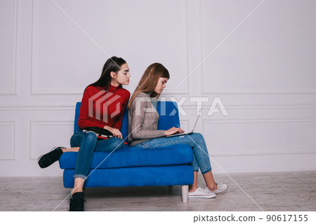 Concentrated women working on project together Concentrated women working on project together 90617155