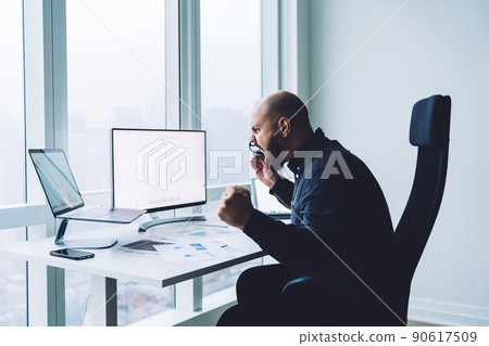 Angry male employee working at report Angry male employee working at report 90617509