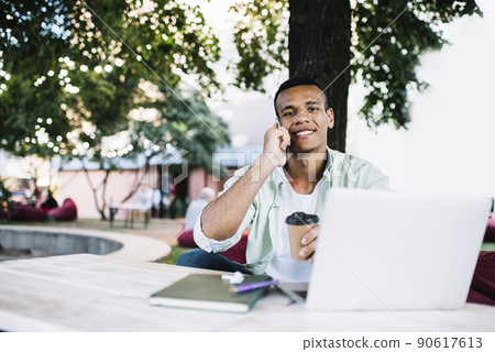 Happy black man speaking on smartphone Happy black man speaking on smartphone 90617613