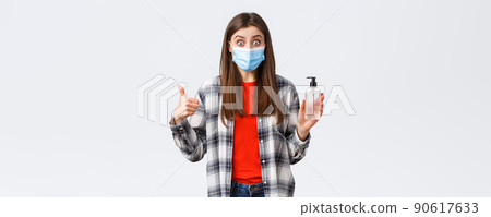 Coronavirus outbreak, leisure on quarantine, social distancing and emotions concept. Amazed and impressed girl in medical mask, want prevent catching virus, thumb-up good hand sanitizer Coronavirus outbreak, leisure on quarantine, social distancing and emotions concept. Amazed and impressed girl in medical mask, want prevent catching virus, thumb-up good hand sanitizer 90617633