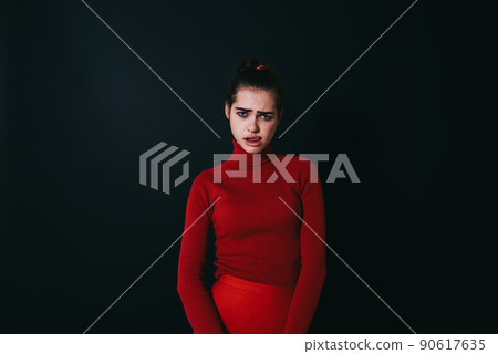 Sad woman sticking out tongue and frowning Sad woman sticking out tongue and frowning 90617635