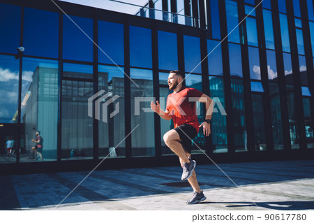 Young sportsman training near building 90617780