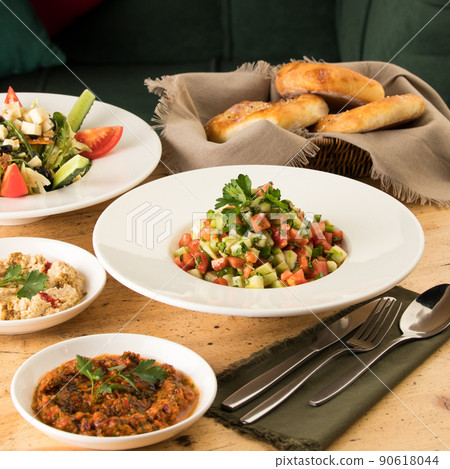 Close up shot of salads and appetizers near basket of breads 90618044