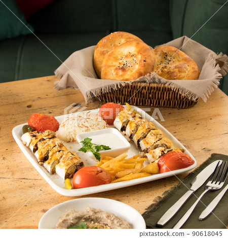 Dining table full of delicious dishes and a basket of bread 90618045