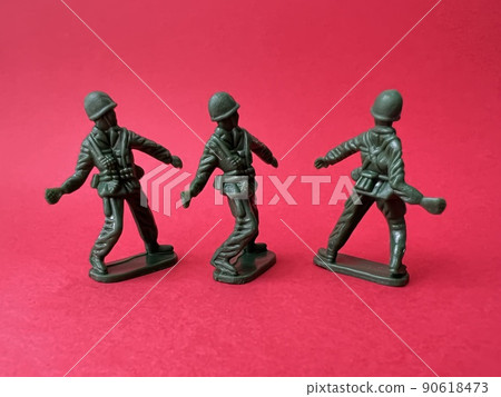 Three soldier dolls throwing grenades (red background), war and terrorist images 90618473