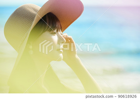 Young woman enjoying a resort on the beach Young woman enjoying a resort on the beach 90618926