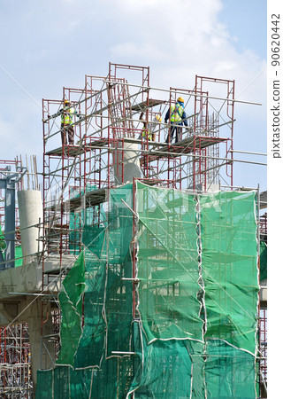JOHOR, MALAYSIA -APRIL 13, 2016: Scaffolding used as the temporary structure to support platform, form work and structure at the construction site. Also used it as a walking platform for workers.  90620442