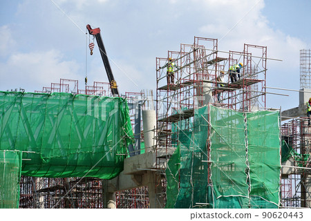 JOHOR, MALAYSIA -APRIL 13, 2016: Scaffolding used as the temporary structure to support platform, form work and structure at the construction site. Also used it as a walking platform for workers. JOHOR, MALAYSIA -APRIL 13, 2016: Scaffolding used as the temporary structure to support platform, form work and structure at the construction site. Also used it as a walking platform for workers. 90620443