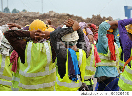 PERAK, MALAYSIA -APRIL 27, 2016: Group of construction workers assemble at the open space in construction site. PERAK, MALAYSIA -APRIL 27, 2016: Group of construction workers assemble at the open space in construction site. 90620468