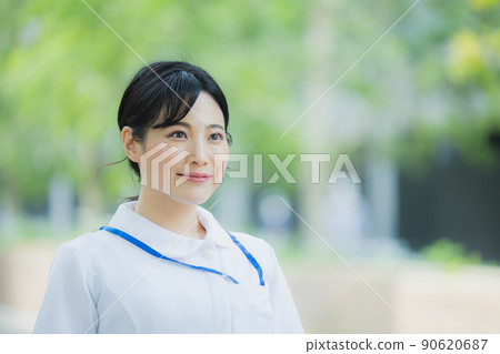 Woman in a white coat outdoors Woman in a white coat outdoors 90620687