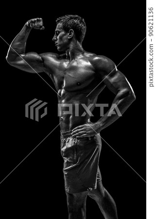 Muscular and fit young bodybuilder fitness male model posing ove 90621136
