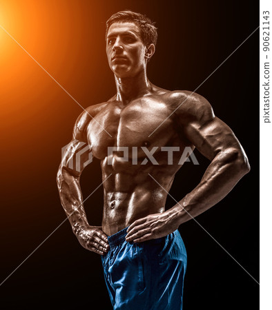 Muscular and fit young bodybuilder fitness male model posing ove Muscular and fit young bodybuilder fitness male model posing ove 90621143