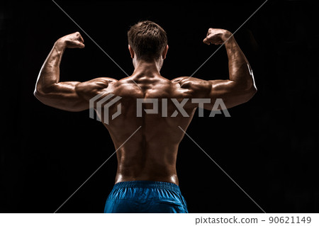 Strong Athletic Man Fitness Model posing back muscles, triceps over black background 90621149