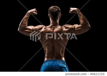 Strong Athletic Man Fitness Model posing back muscles, triceps over black background Strong Athletic Man Fitness Model posing back muscles, triceps over black background 90621150