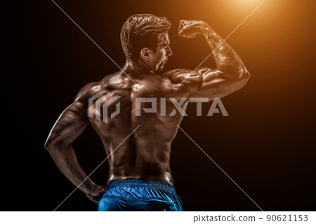 Strong Athletic Man Fitness Model posing back muscles, triceps o Strong Athletic Man Fitness Model posing back muscles, triceps o 90621153