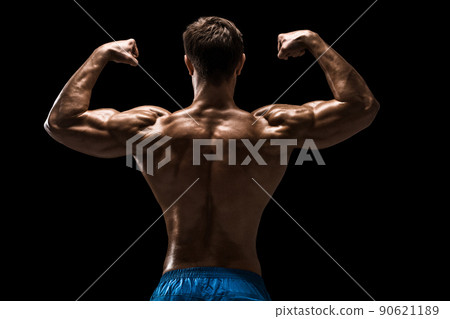 Strong Athletic Man Fitness Model posing back muscles, triceps over black background Strong Athletic Man Fitness Model posing back muscles, triceps over black background 90621189