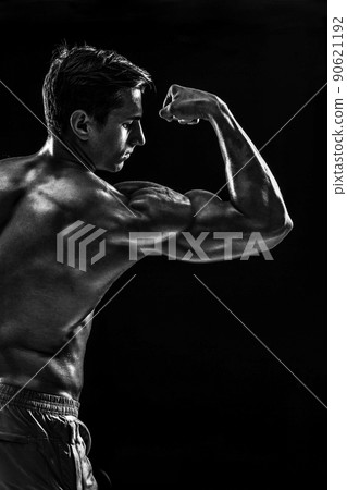 Strong Athletic Man Fitness Model posing back muscles, triceps o Strong Athletic Man Fitness Model posing back muscles, triceps o 90621192