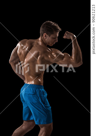 Strong Athletic Man Fitness Model posing back muscles, triceps over black background 90621213