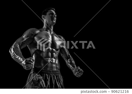 Muscular and fit young bodybuilder fitness male model posing ove Muscular and fit young bodybuilder fitness male model posing ove 90621216