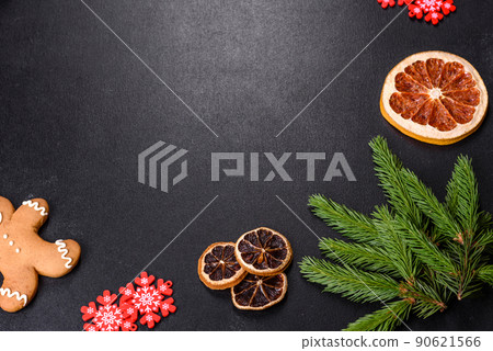 Festive Christmas table with appliances, gingerbreads, tree branches and dried citrus trees Festive Christmas table with appliances, gingerbreads, tree branches and dried citrus trees 90621566