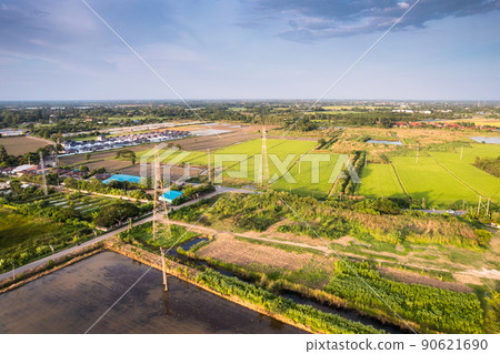 High voltage pole, Transmission tower, Electricity pylon, Electric power transmission located on rice field in the countryside High voltage pole, Transmission tower, Electricity pylon, Electric power transmission located on rice field in the countryside 90621690